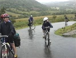 The last few riders pedal bravely up the hill at Sarn Helen, just below Devil's Elbow